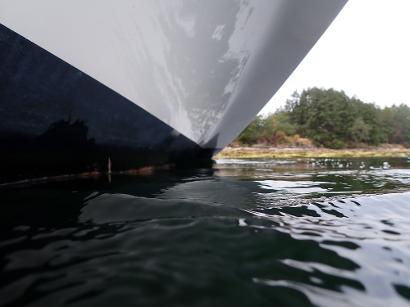 Clean boat hull at the waterline after underwater maintenance